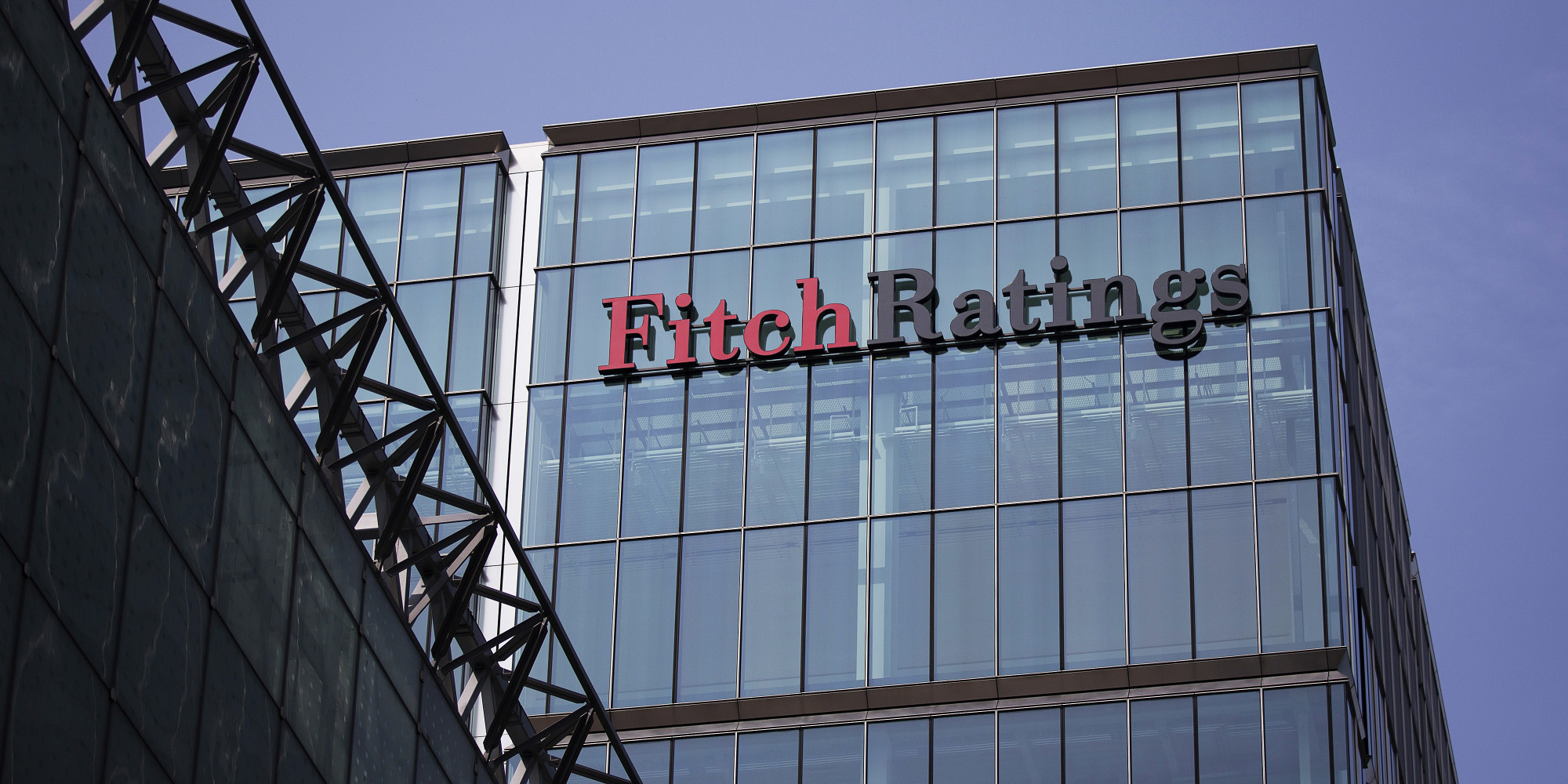 The headquarters of Fitch Ratings Ltd. stands in the Canary Wharf business and shopping district in London, U.K., on Friday, July 12, 2013. Recent data suggest Britain's economic recovery is gaining momentum after a return to growth in the first quarter. Photographer: Simon Dawson/Bloomberg via Getty Images